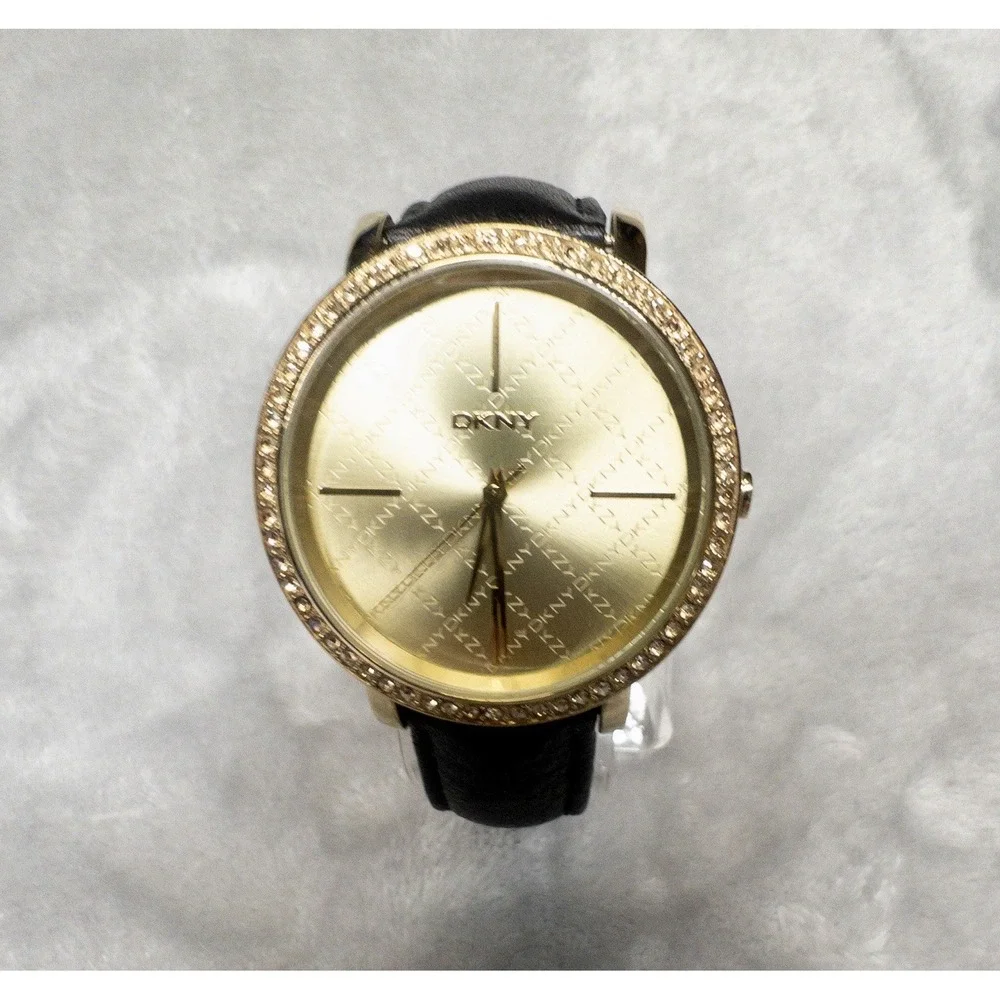 DKNY 111007 Gold Tone All Over Logo Womens 43mm Wristwatch Gem Set Bezel